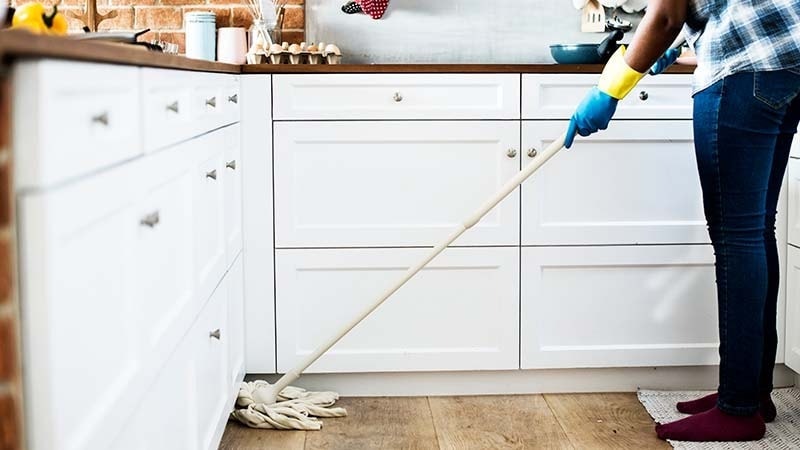 A man mopping his kitchen floors
