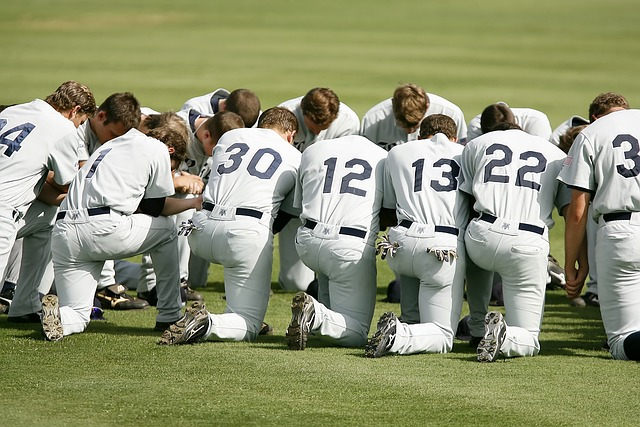 baseball team, prayer, kneeling