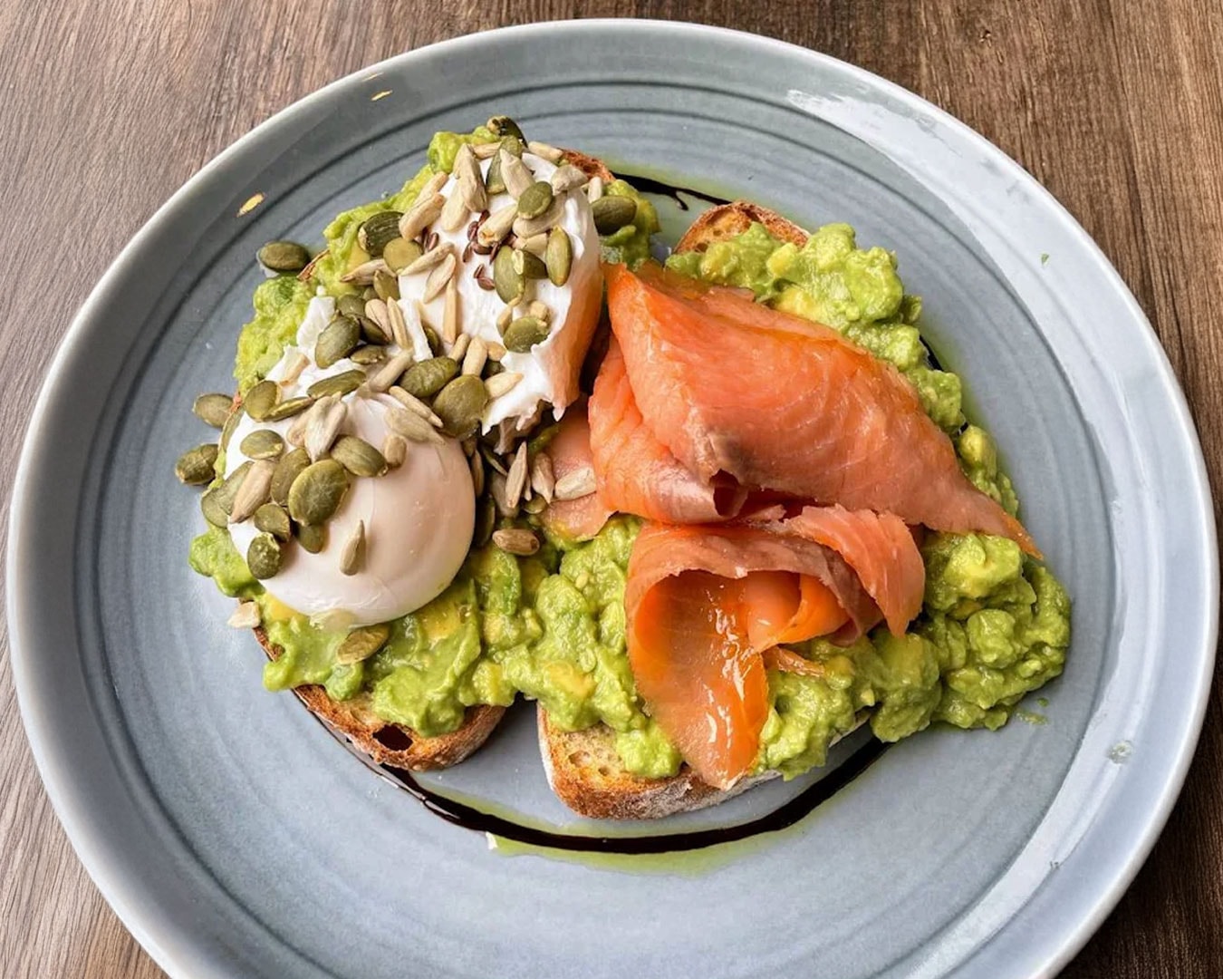 Thick-cut toast layered with ripe avocado and smooth egg mayonnaise, offering a fresh and satisfying combination of textures and flavours.