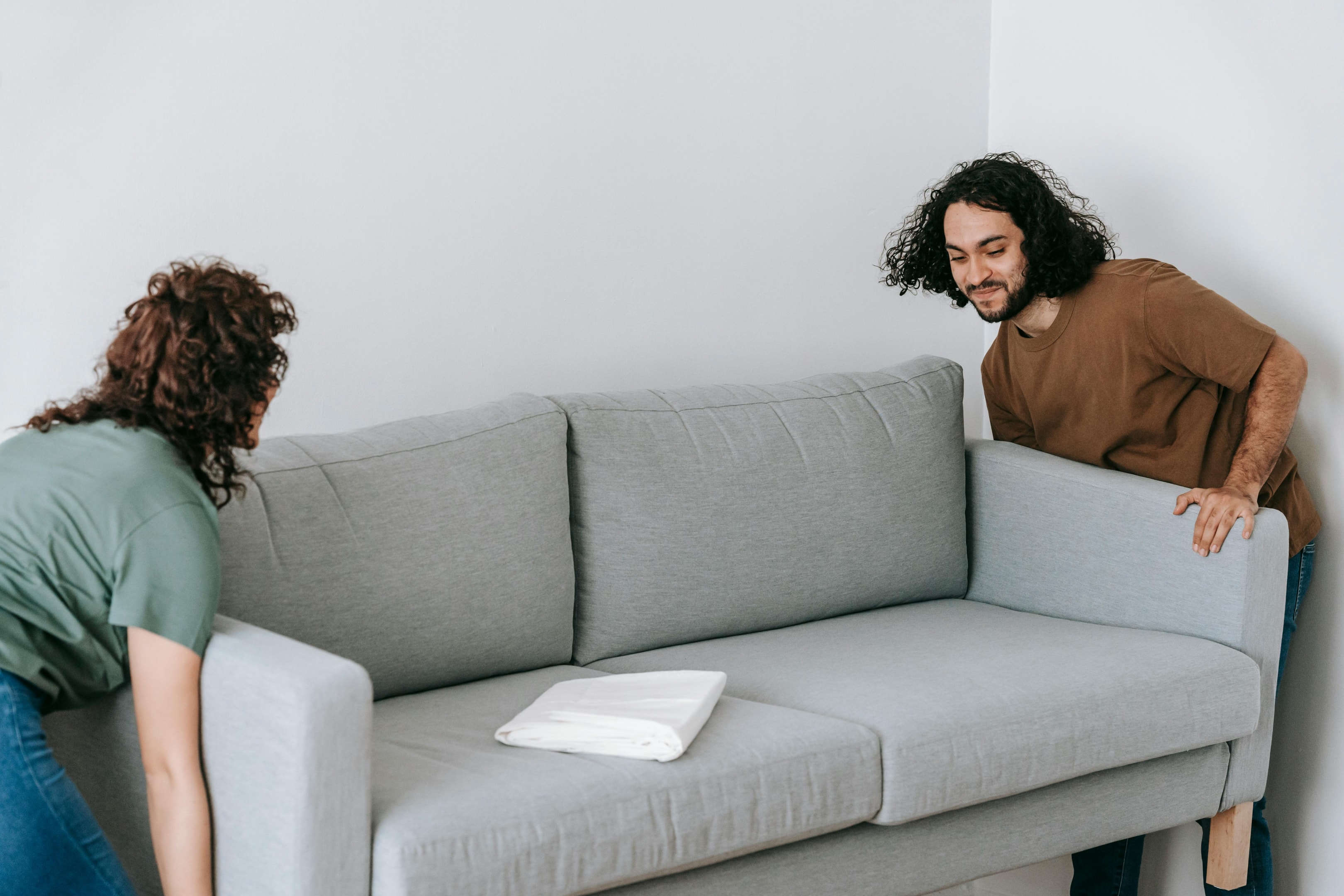 Photo by Blue Bird: https://www.pexels.com/photo/couple-moving-sofa-in-room-7217785/