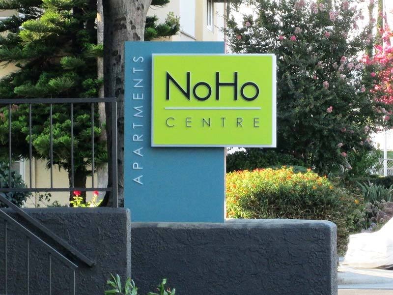 The NoHo Centre Apartments monument sign in Los Angeles, CA, features channel letters for illumination. A closer look below shows the lighting details.