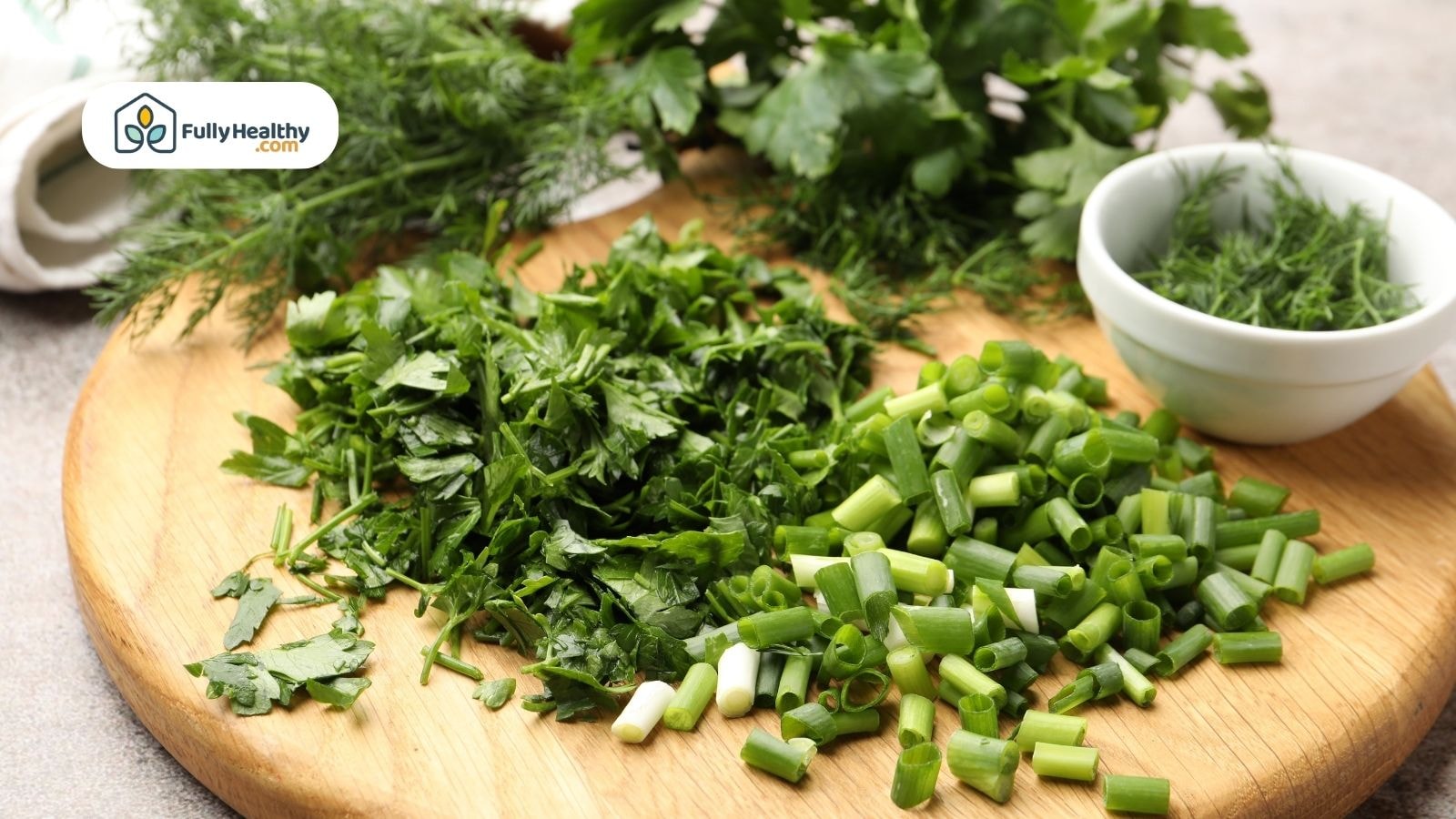Chopped fresh herbs including cilantro, parsley, and green onion on cutting board