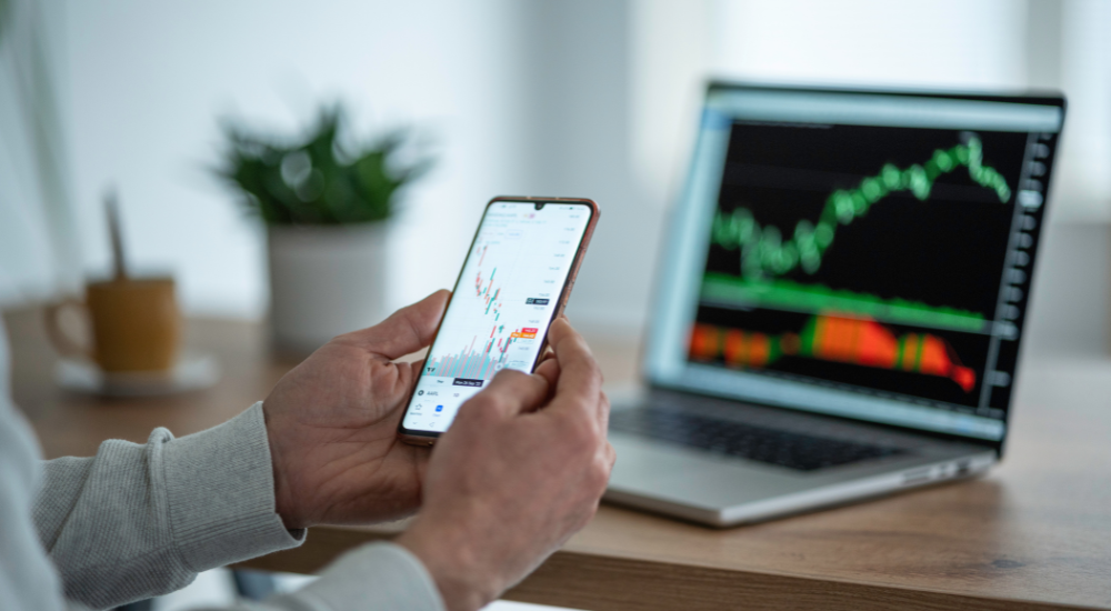 A man looking at stocks on a phone