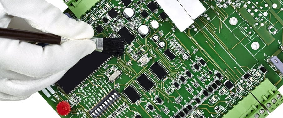 Use a brush to clean the PCB motherboard.