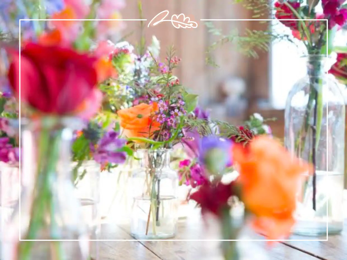 Vibrant and colorful floral arrangements in glass vases as wedding table decor. Fabulous Flowers & Gifts