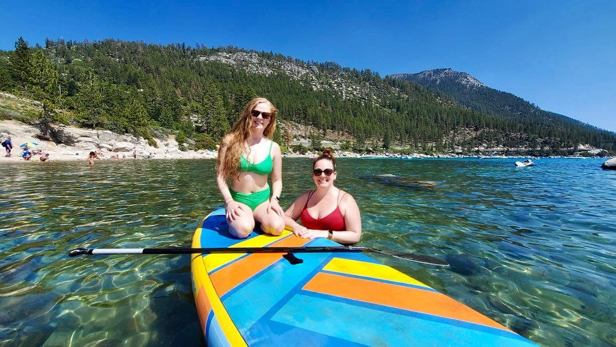 kneeling on an inflatable paddleboard on lake tahoe