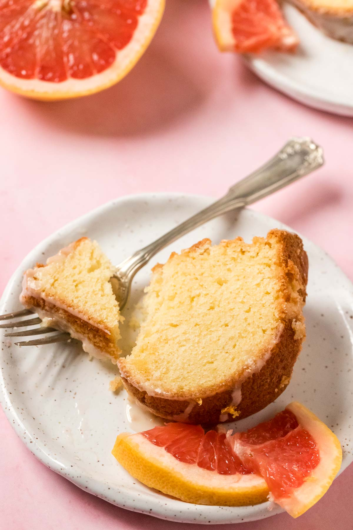 slice of grapefruit pound cake on a plate with a fork