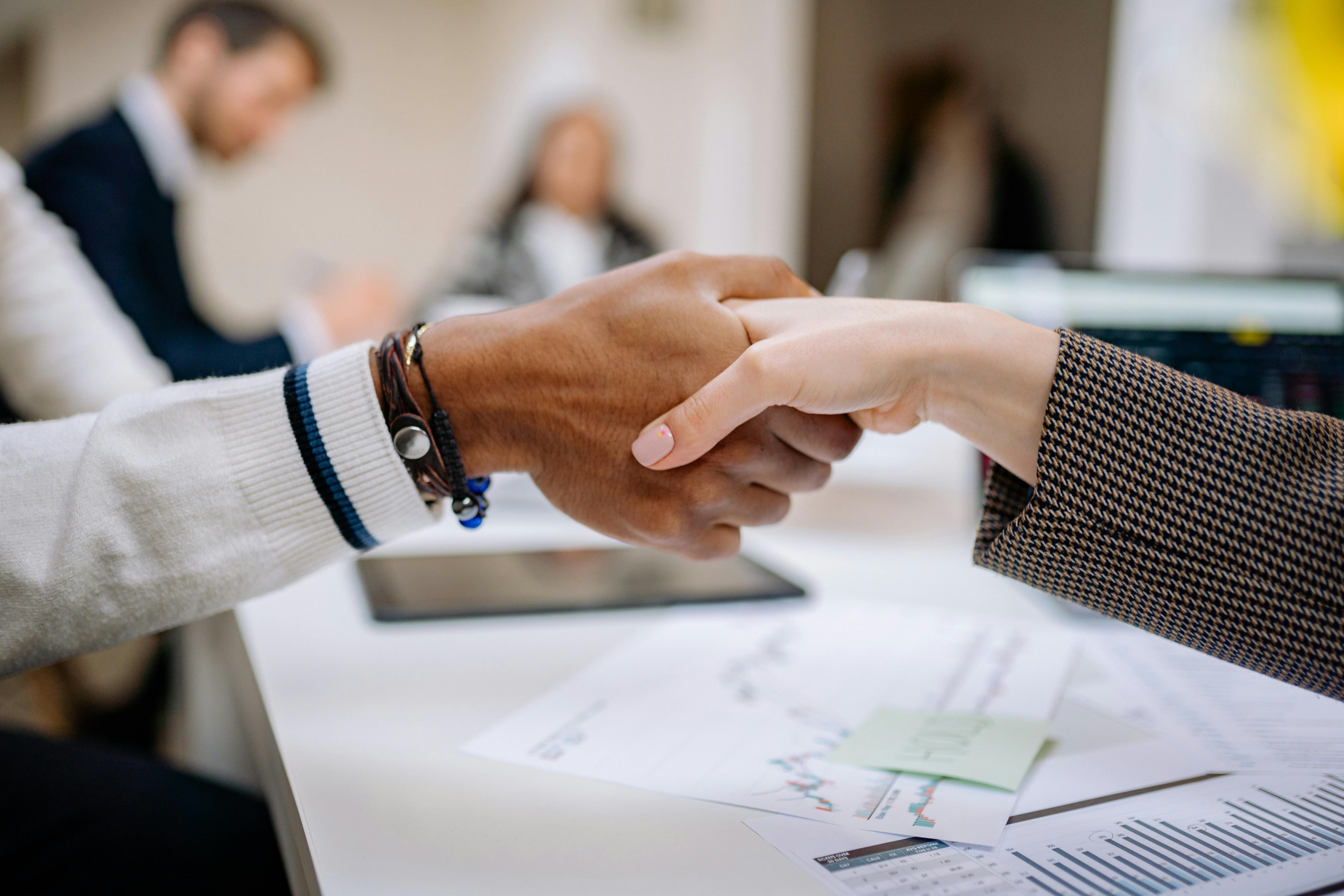 two people shaking hands in office