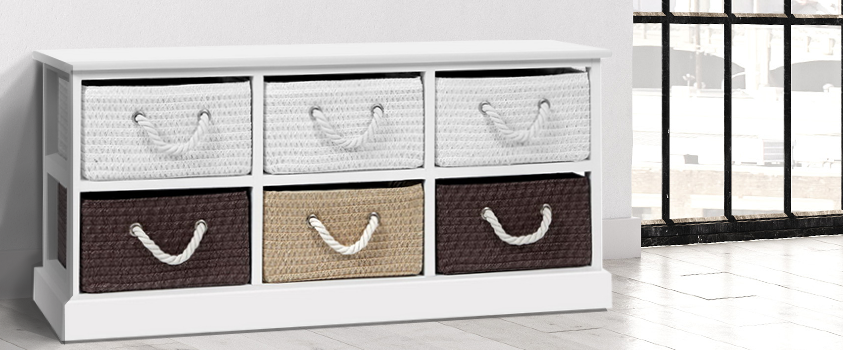 An Artiss White 6 Drawer Storage Bench with 6 woven fabric baskets in white, brown and light brown. It is in a room against a white wall and light wood floor. To the right is a cast iron window.