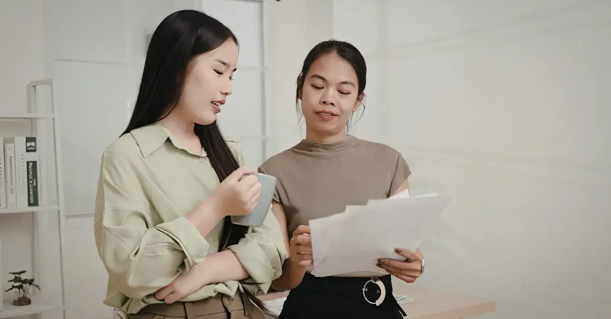 Woman and tax professional reviewing form 9423, bank statements, and supporting documents for an IRS collection appeal.