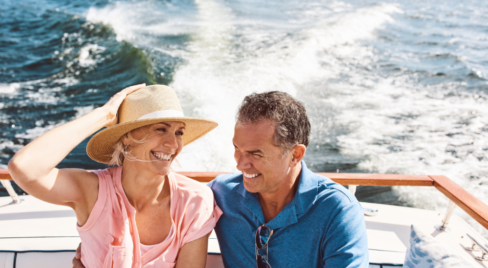 Happy couple on a Speed-boat enjoying retirement