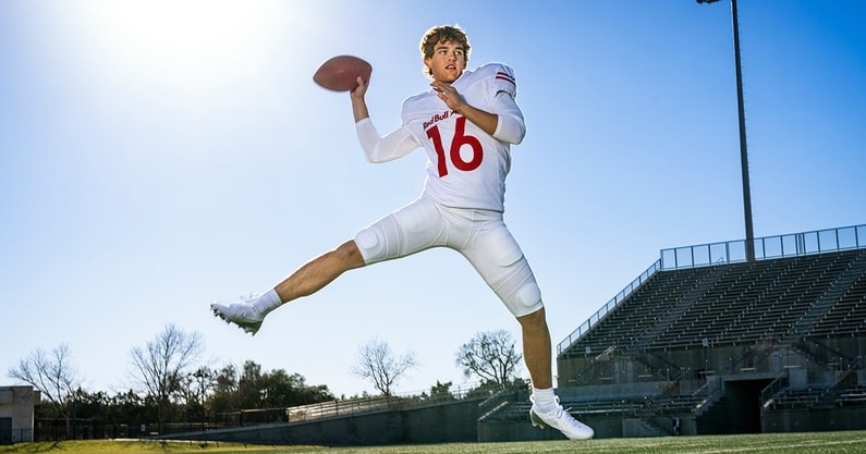 Texas quarterback Arch Manning holding a football, representing his high NIL valuation with major endorsements in collegiate sports.