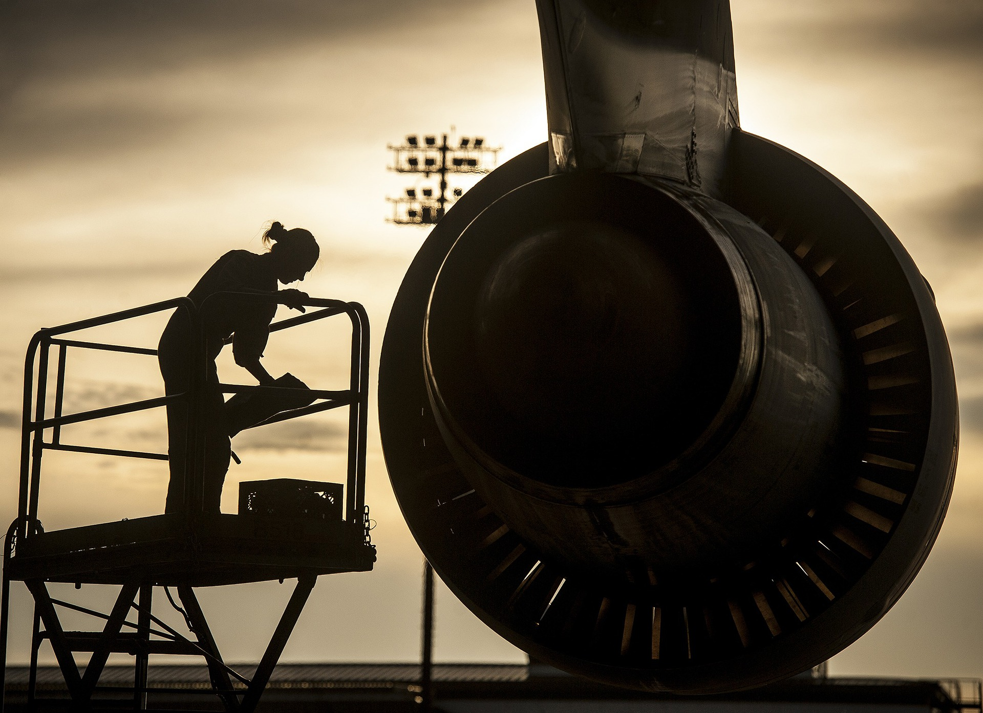 An aircraft mechanic performing engine checks on an aircraft.