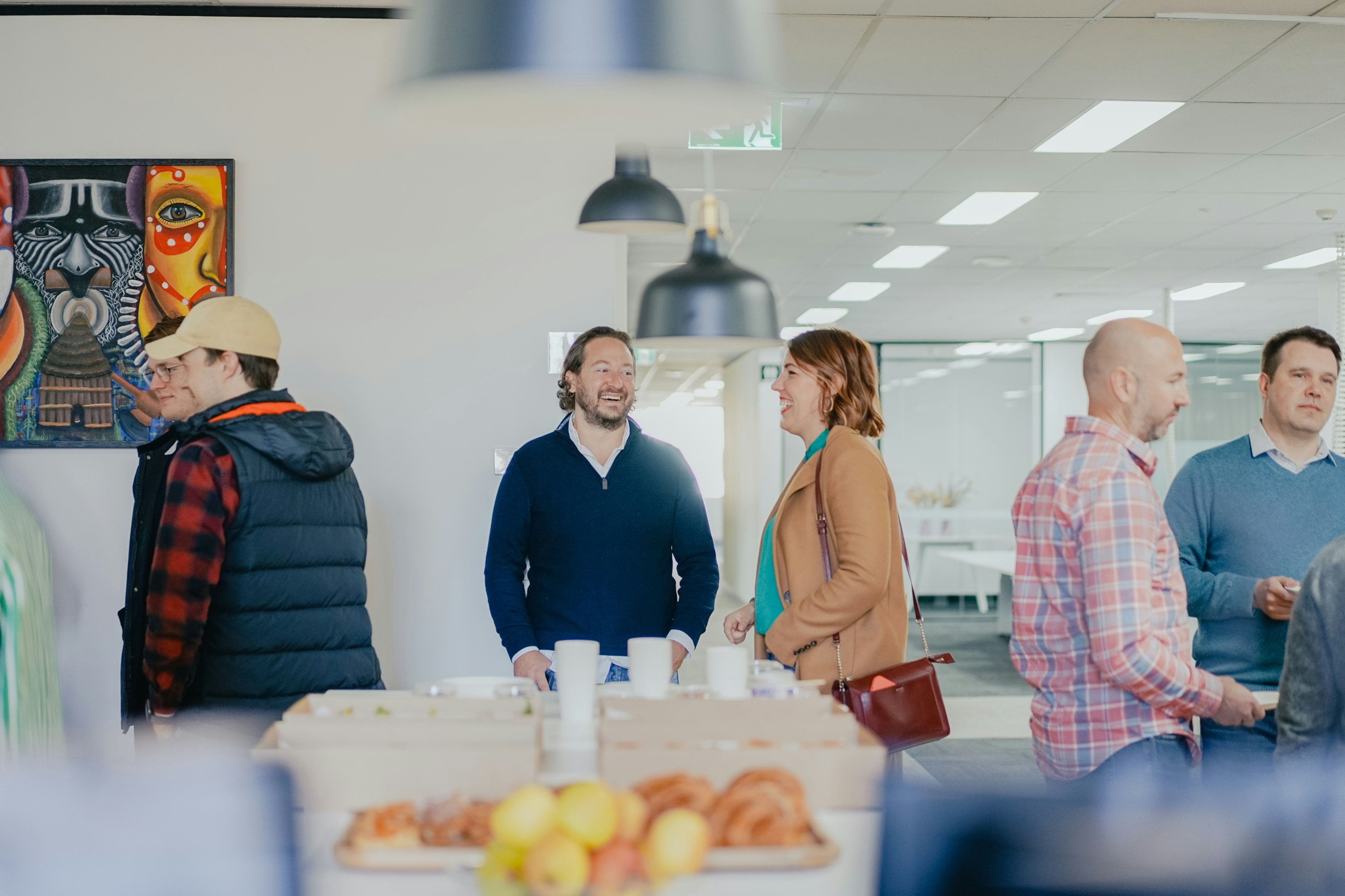 Real estate investors and agents chat a local meetup of a high level real estate course.