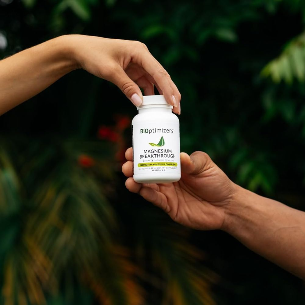 A person holding a bottle of magnesium supplement with a label that reads "Magnesium Boost"