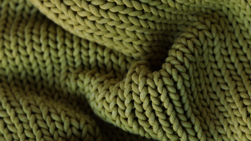 A close-up of a green knitted blanket