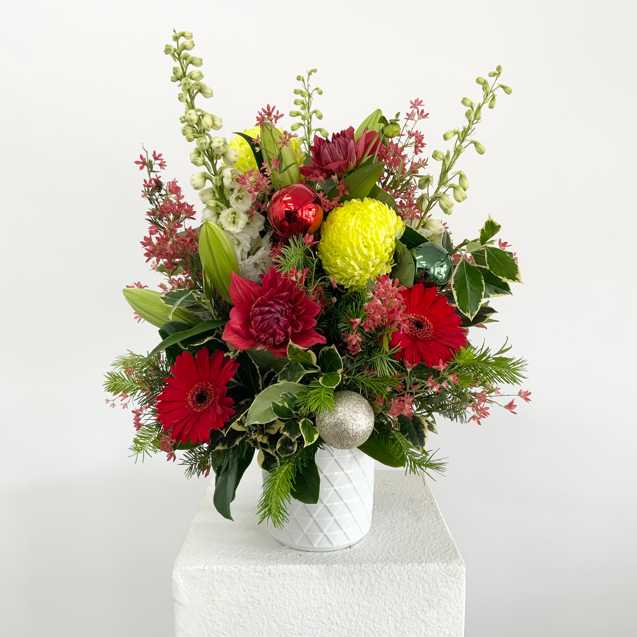 A beautiful arrangement of Christmas flower decorations, perfect for gifting to loved ones during the holiday season.