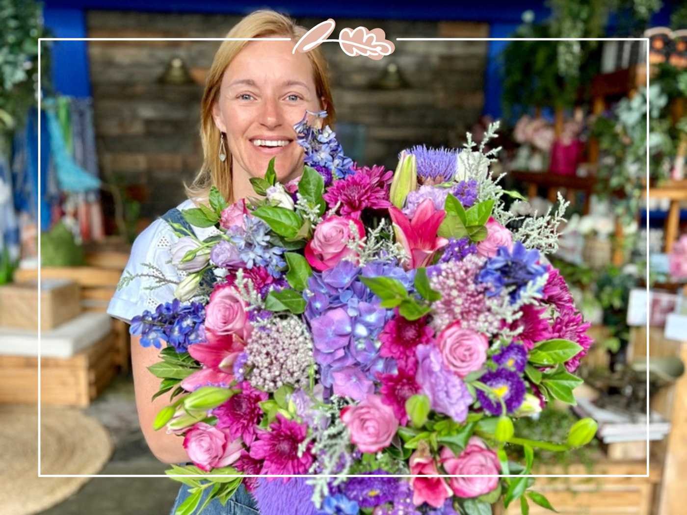 Woman smiling while holding a large colorful bouquet of flowers - Fabulous Flowers and Gifts