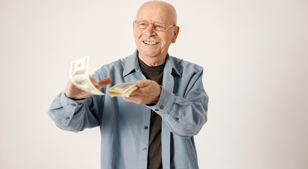 Happy old man scattering money