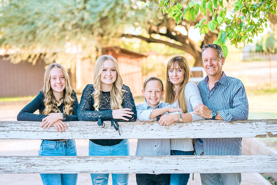 A family posing together in coordinated outfits for a photo session, showcasing outfit ideas for family photos.