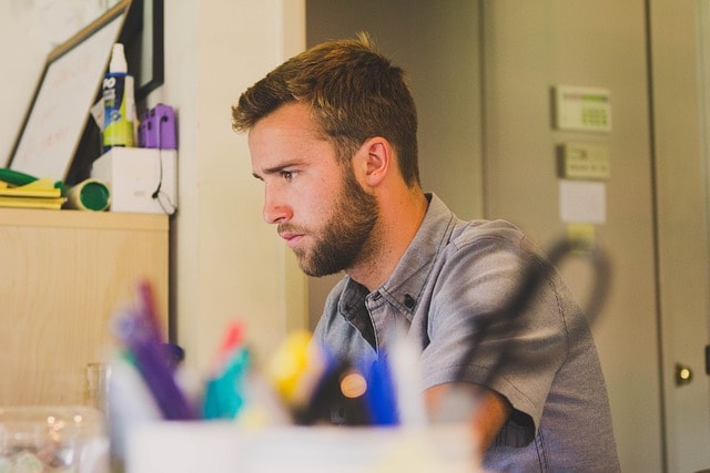 Man sitting at desk looking at computer