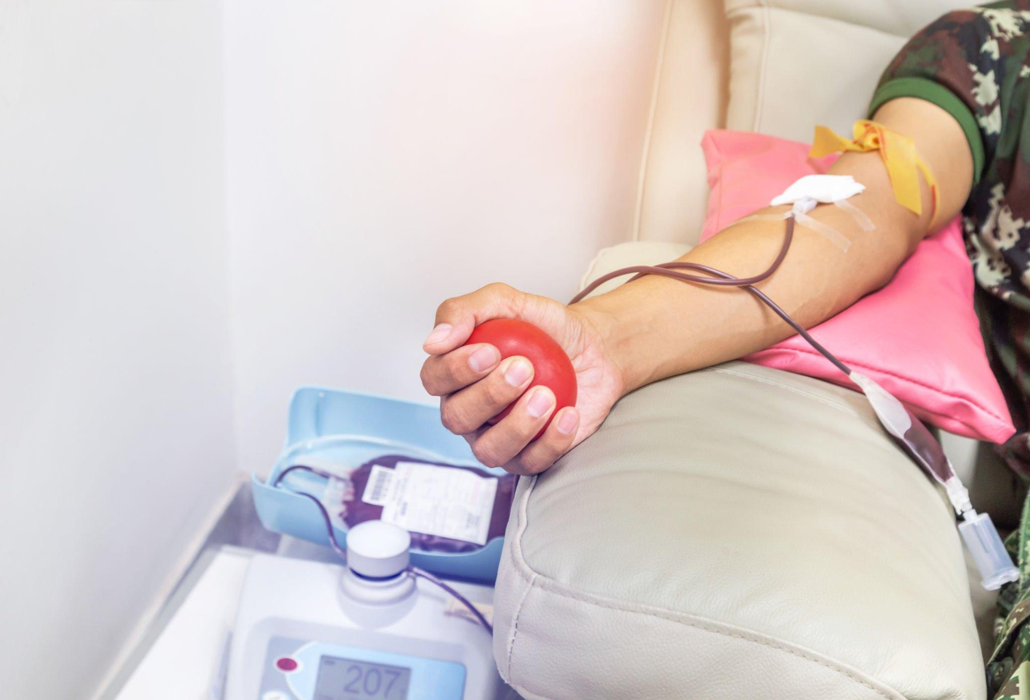 A person having their blood drawn for a Fasting Plasma Glucose test, a blood sugar test that requires fasting beforehand.