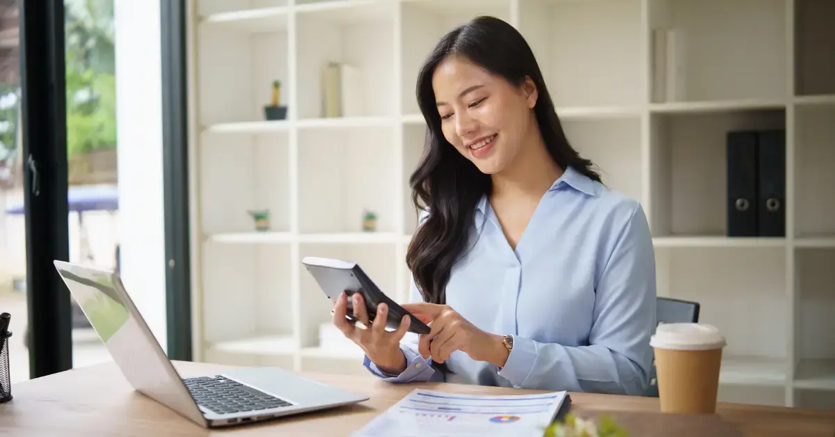Woman reviewing finances and tax documents using Form 3115 instructions for accounting method corrections.