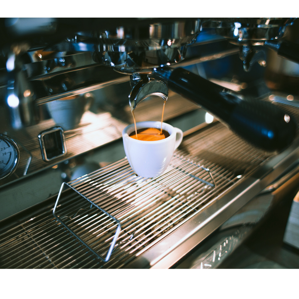 An espresso machine with a cup of espresso