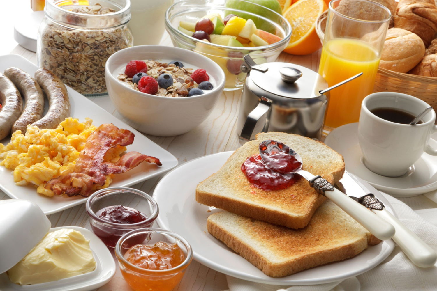 Healthy breakfast with eggs, water, and fruit on a bright kitchen table.