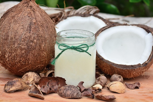 coconuts split open with a jar of MCT oil for making CBD oil