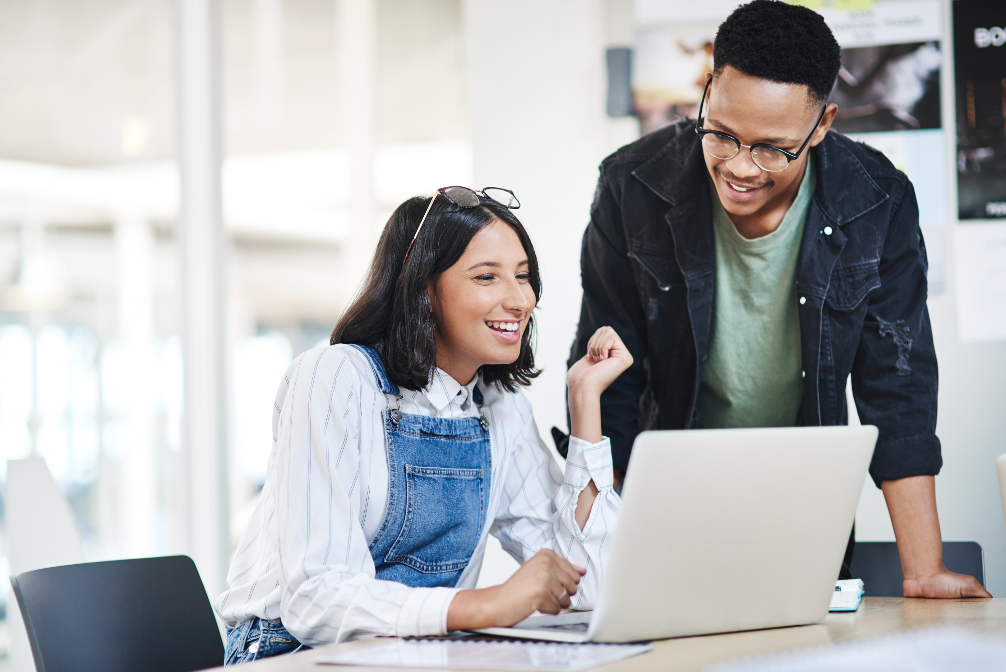 Two people using a laptop