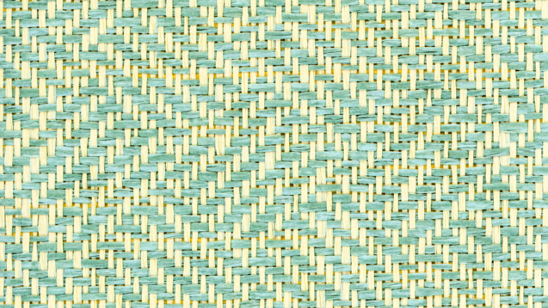 A close up image of a green and white twill fabric