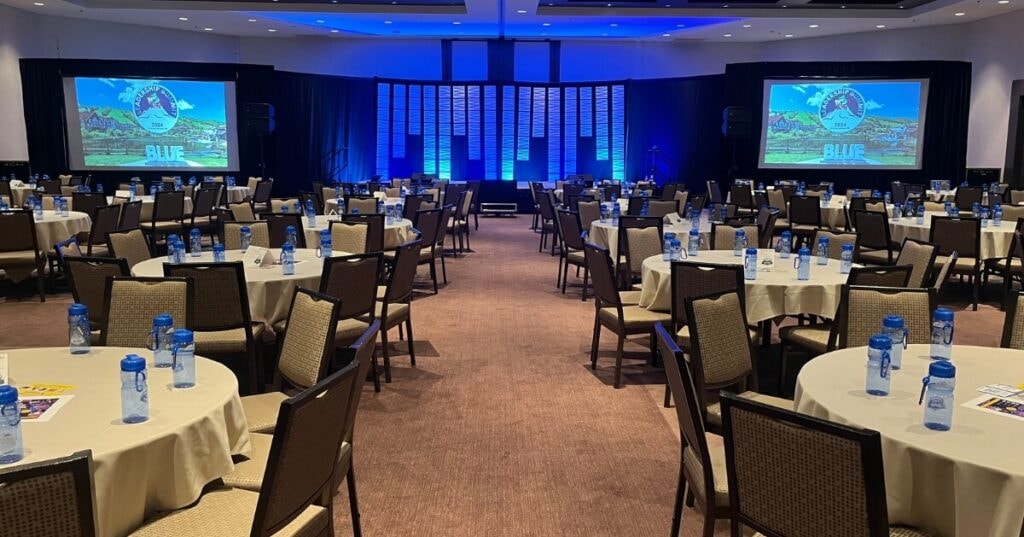 Professional audiovisual setup for corporate event with projector and sound system.
