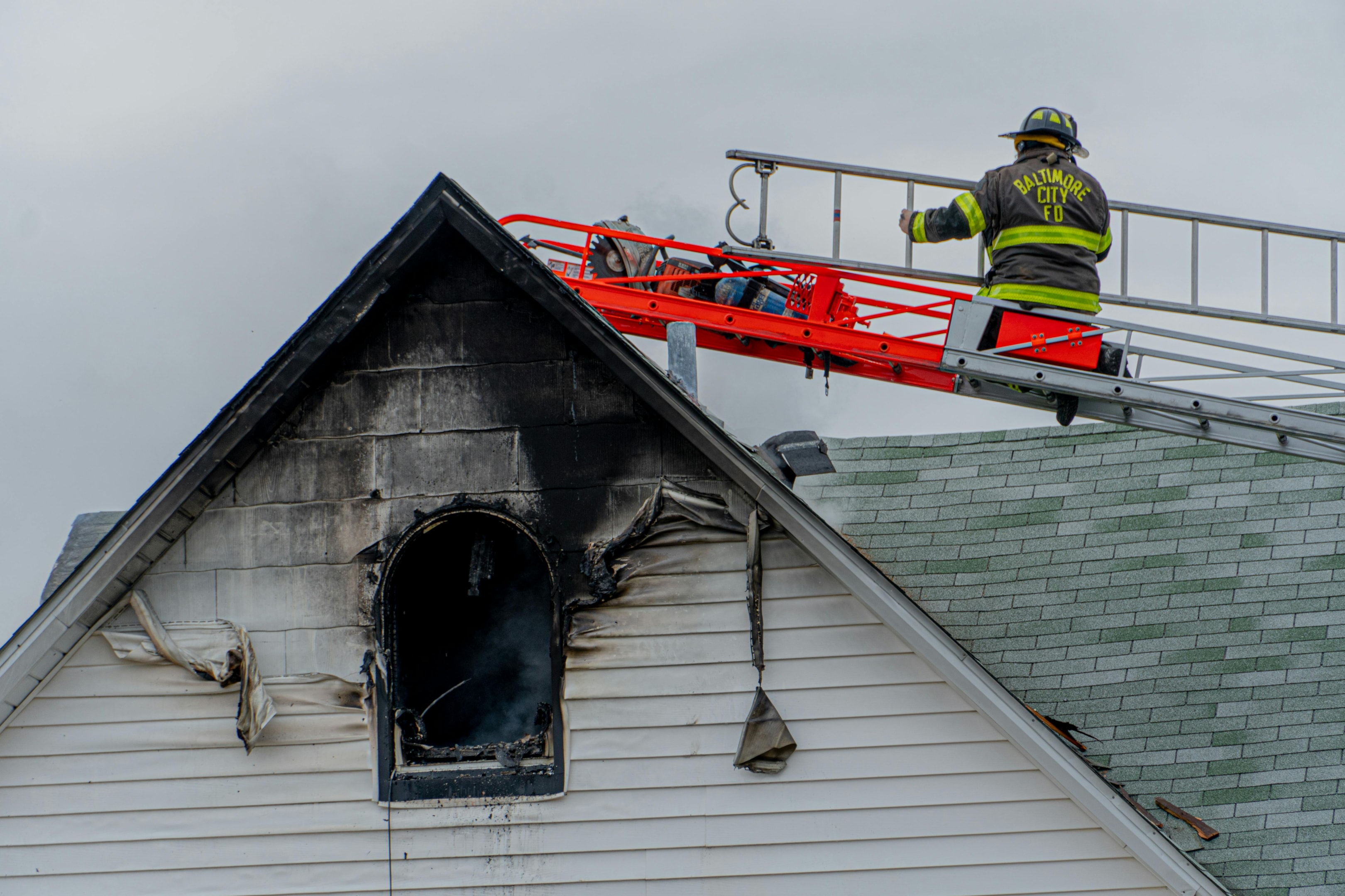 Firefighter works on putting out electrical fire at single family house.