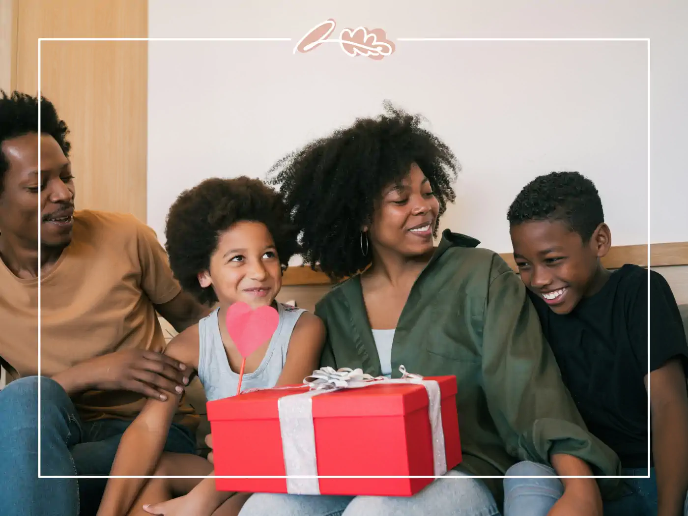 Family sitting together, giving a red gift box - fabulous flowers and gifts