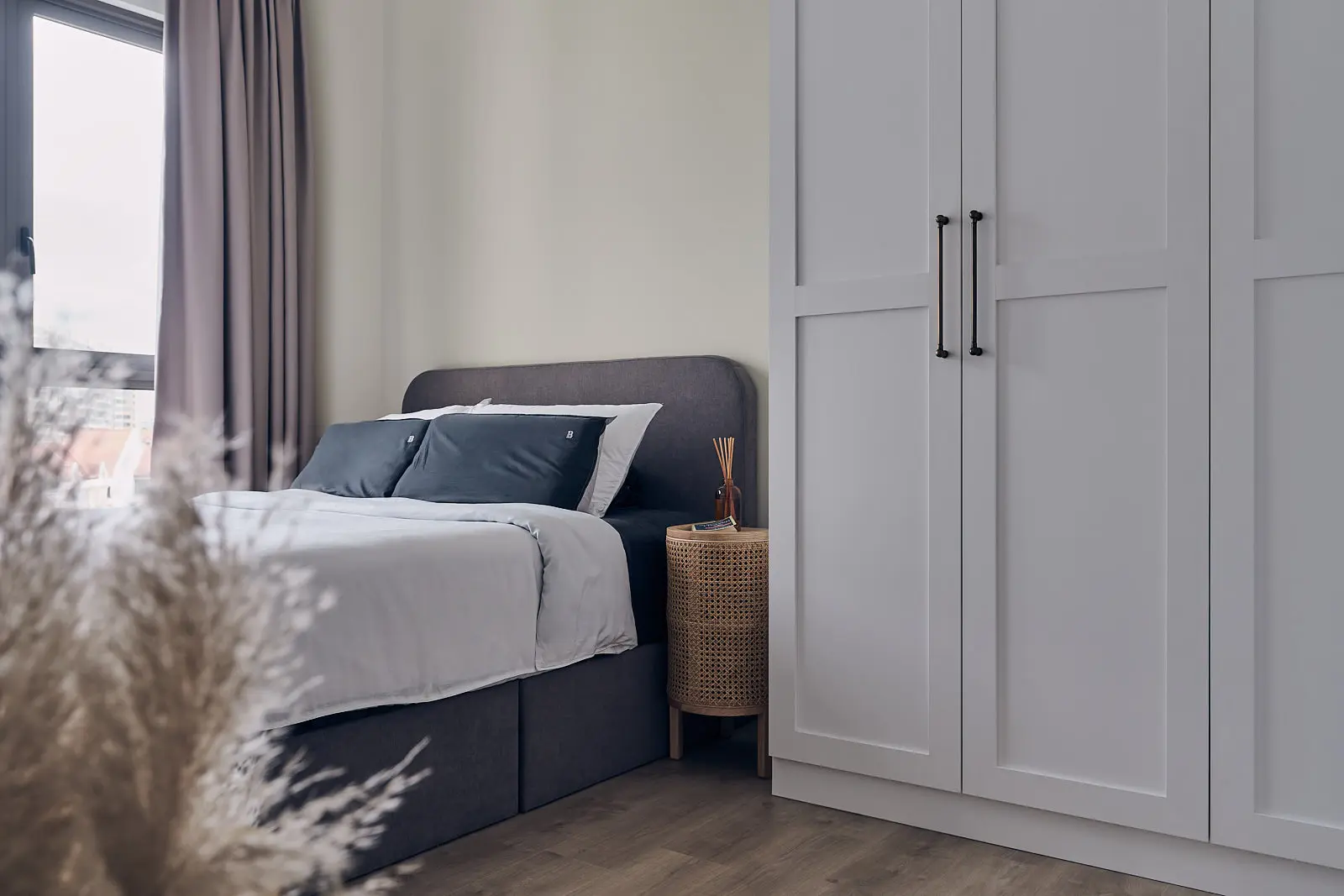Scandinavian ottoman storage bed with shaker wardrobe – stylish bed ideas for small rooms.