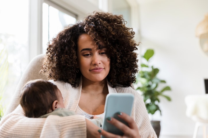 Young mom holding a baby. 