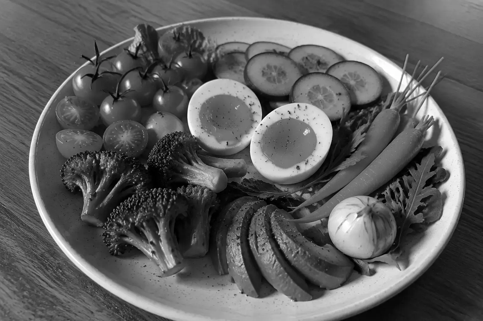 A vegetarian plate featuring egg-based dishes paired with fresh vegetables and plant foods.