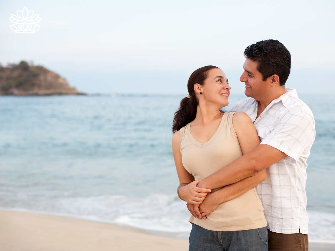 A couple embracing lovingly on a beach, representing the Gift Boxes for Husband Collection - Experience gifts for road trips and coffee lovers - Fabulous Flowers and Gifts