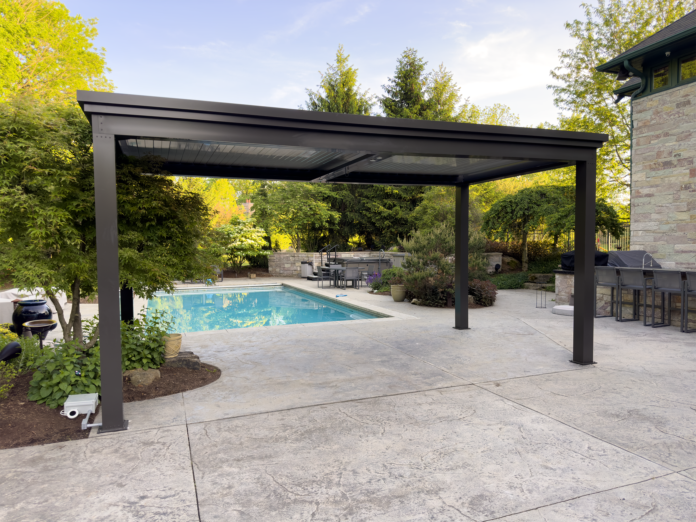 Bronze pergola with louvered roof next to the pool