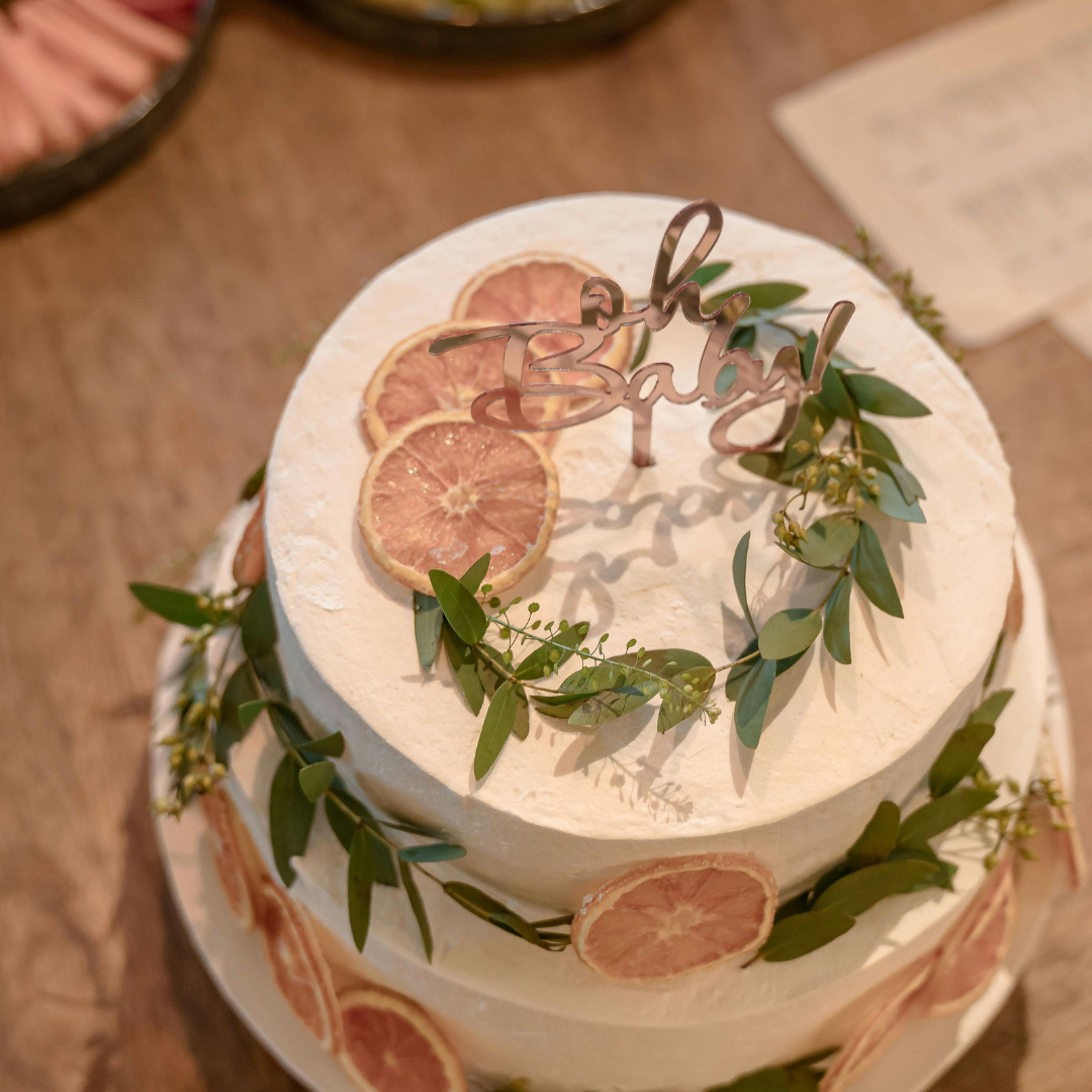 2-layer baby shower cake with dried fruit and edible decorations