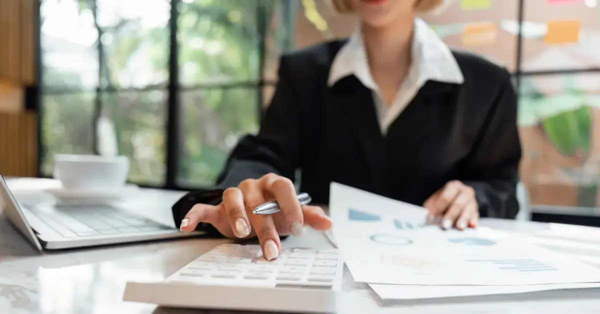 Woman reviewing creator earnings while learning how to calculate monthly gross income for taxes.