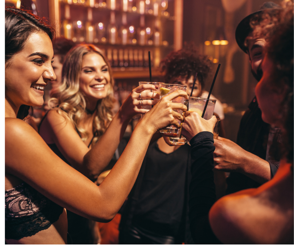 An image showing a group of people socializing after consuming alcohol, illustrating the concept of hindered perspective-taking and the question of why does alcohol make you more social