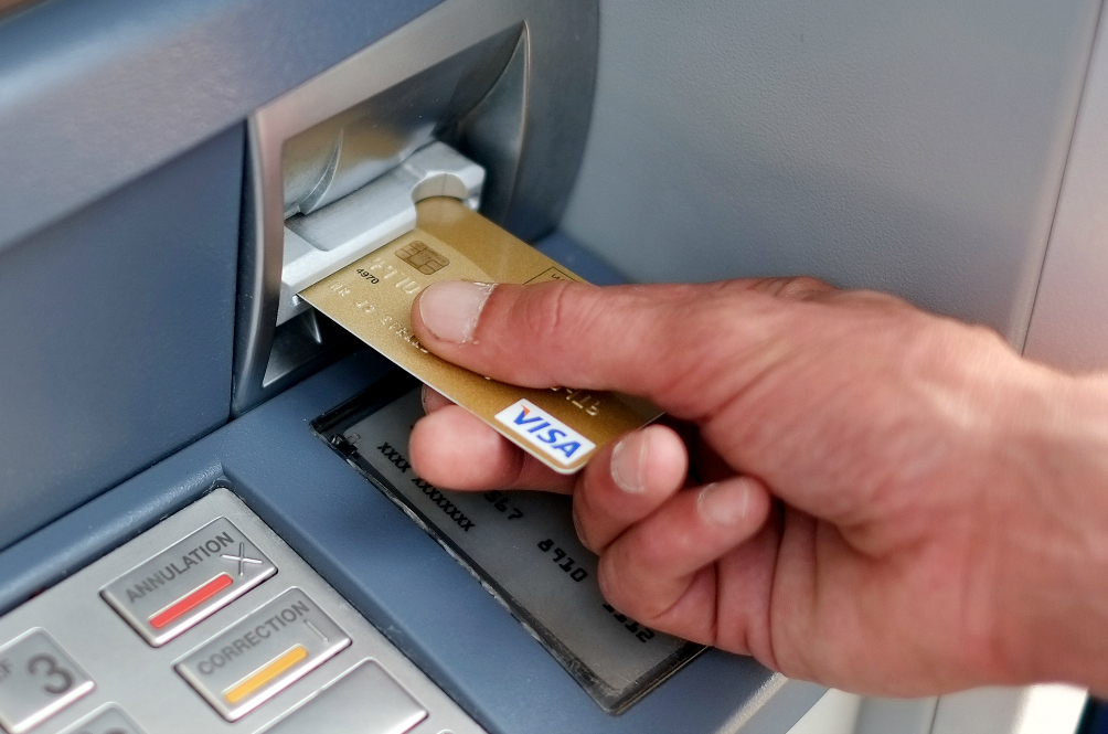 inserting debit card into atm