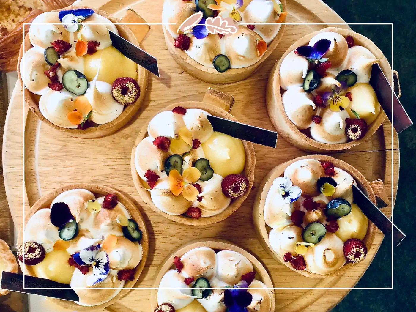 Small dessert cups garnished with edible flowers and berries. Fabulous Flowers and Gifts.