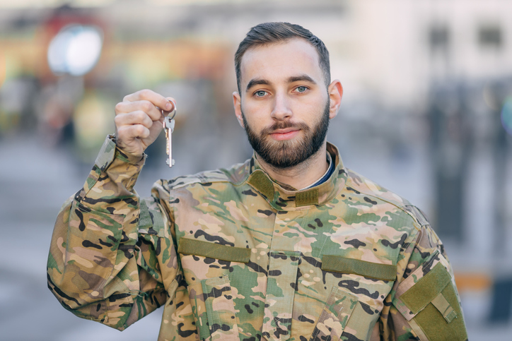 Veteran holding the key to his new store. 