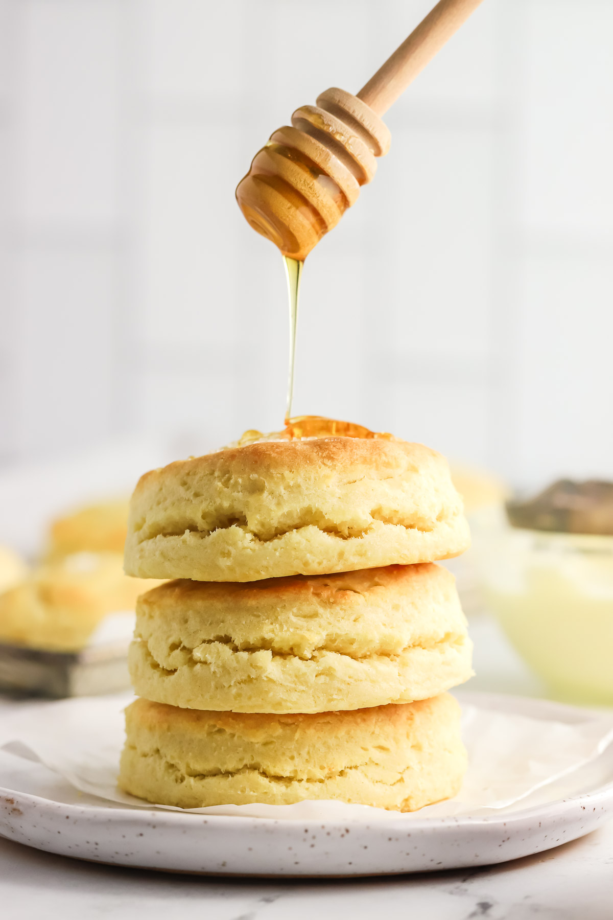 three biscuits stacked on top of each other with honey drizzled over the top