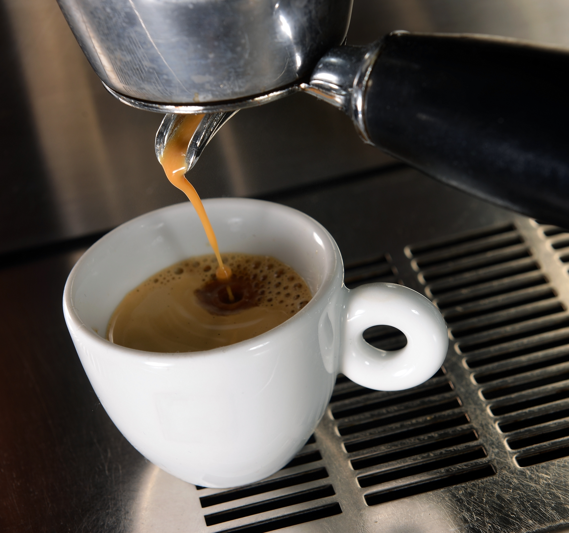 Espresso pouring into cup