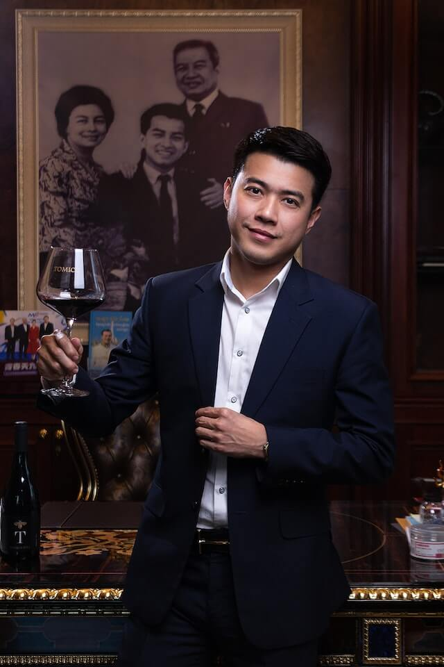 A wine enthusiast holding a glass of wine