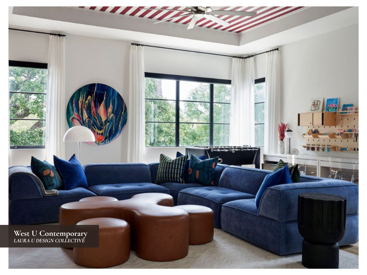 Family game room with a deep blue sectional, berry red built-ins, striped ceiling, and custom leather ottomans.